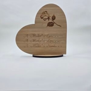 Freestanding wooden heart card with an engraved rose and sentimental “A Mother’s…” message, displayed on a small stand.